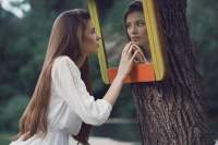 woman-staring-at-herself-in-a-mirror